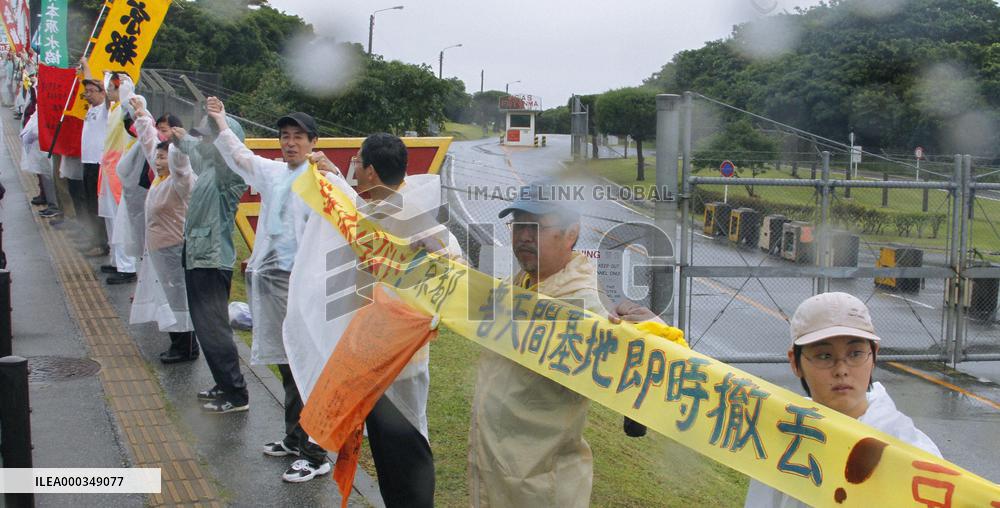 17,000 people encircle Futemma base in 'human chain'