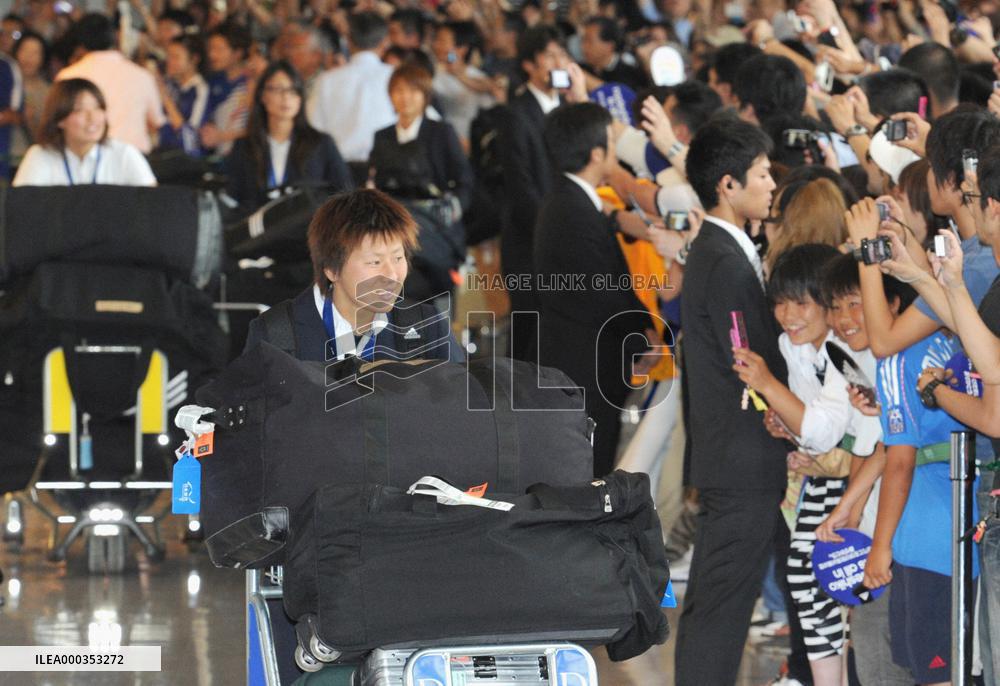 'Nadeshiko Japan' return home after victory