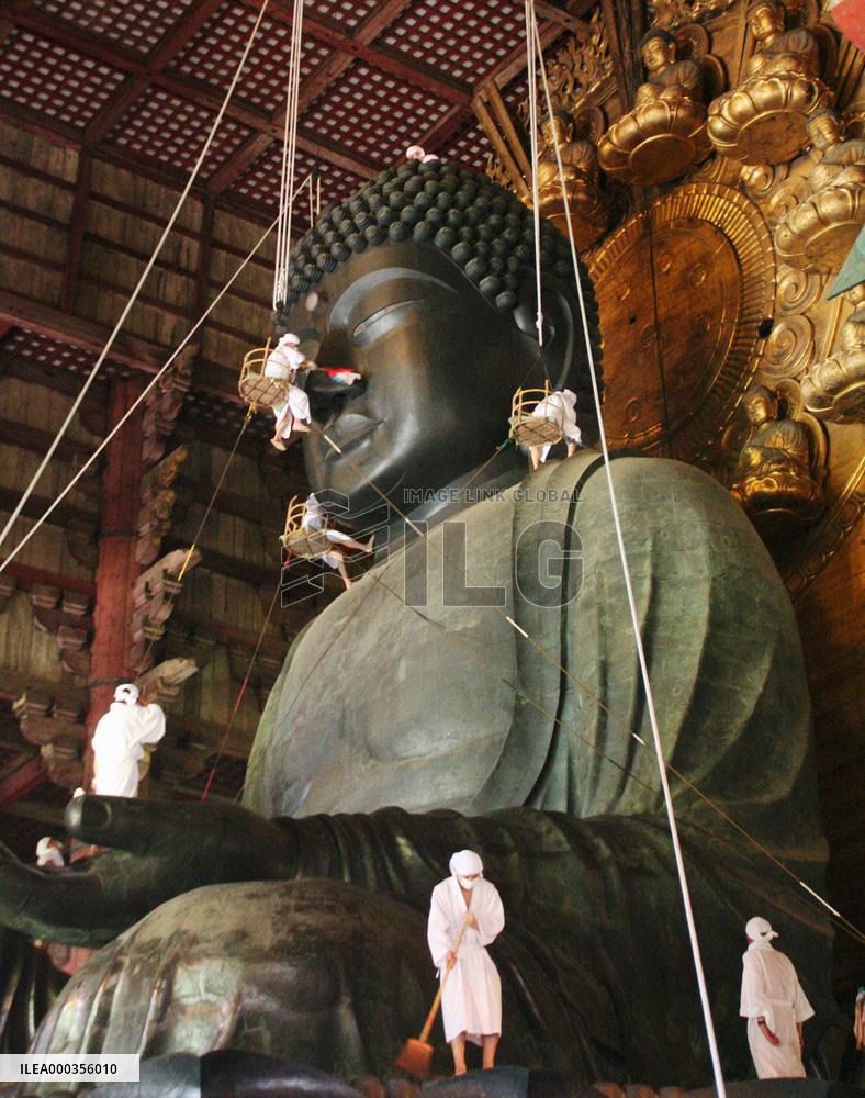 Monks clean massive Buddha statue in Nara
