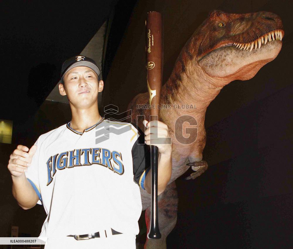 Nippon Ham's Nakata poses with dinosaur