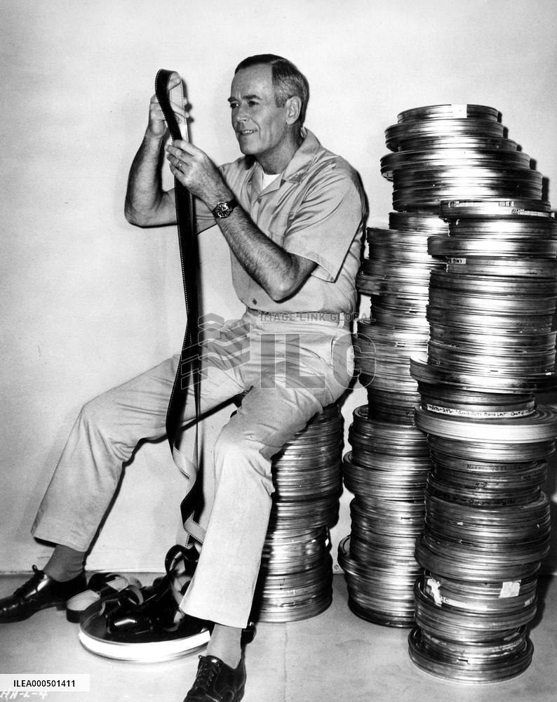 HENRY FONDA LOOKING AT 35MM FILM  FILM HANDLING FILM CANS