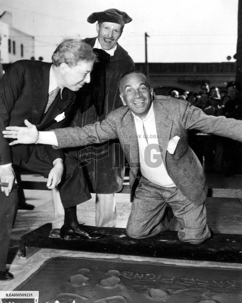Al Jolson celebrating just having made his hand, foot and kn