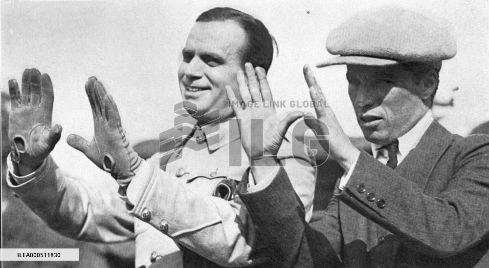 DOUGLAS FAIRBANKS AND CHARLIE CHAPLIN HOLD THEIR HANDS UP TO