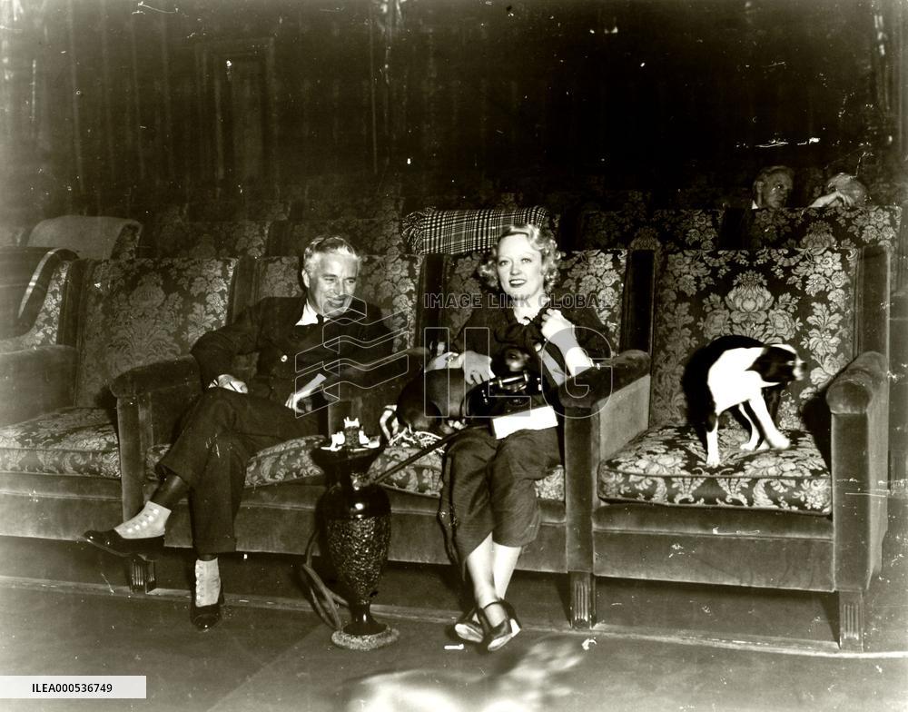 CHARLES CHAPLIN AND MARION DAVIES IN THE PRIVATE CINEMA AT S