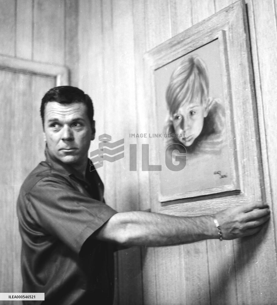 JACKIE COOPER  American actor, at home, with a painting of h