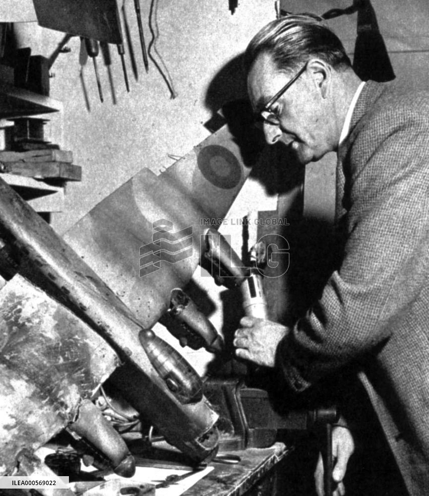 GEORGE BLACKWELL, Special Effects chief, with a model aircra