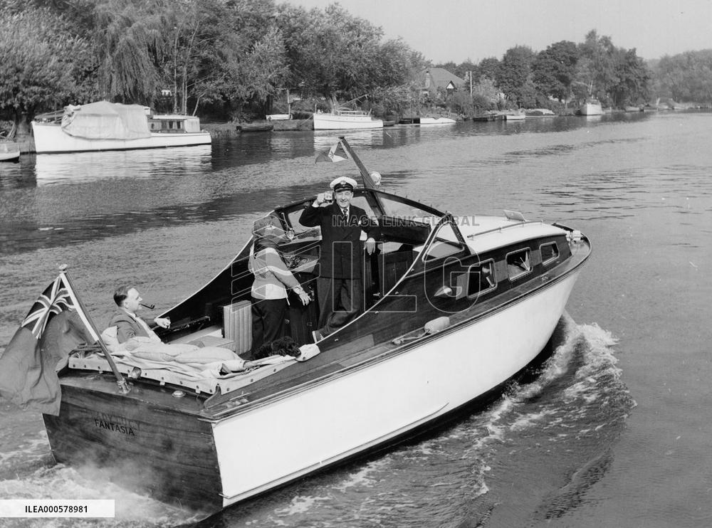 RONALD SHINER and his wife cruising down the river Thames