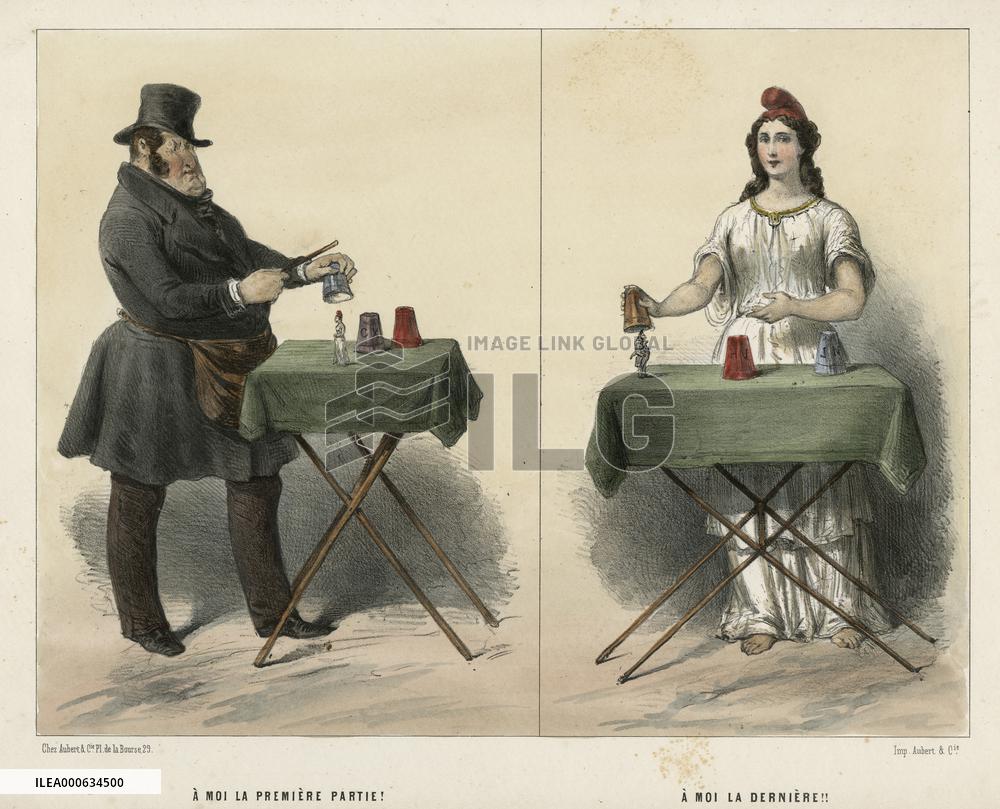 Man and woman magicians performing tricks at table