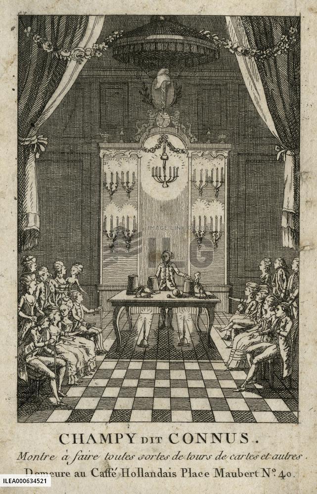 Magician performing the cup and balls trick in front of a se