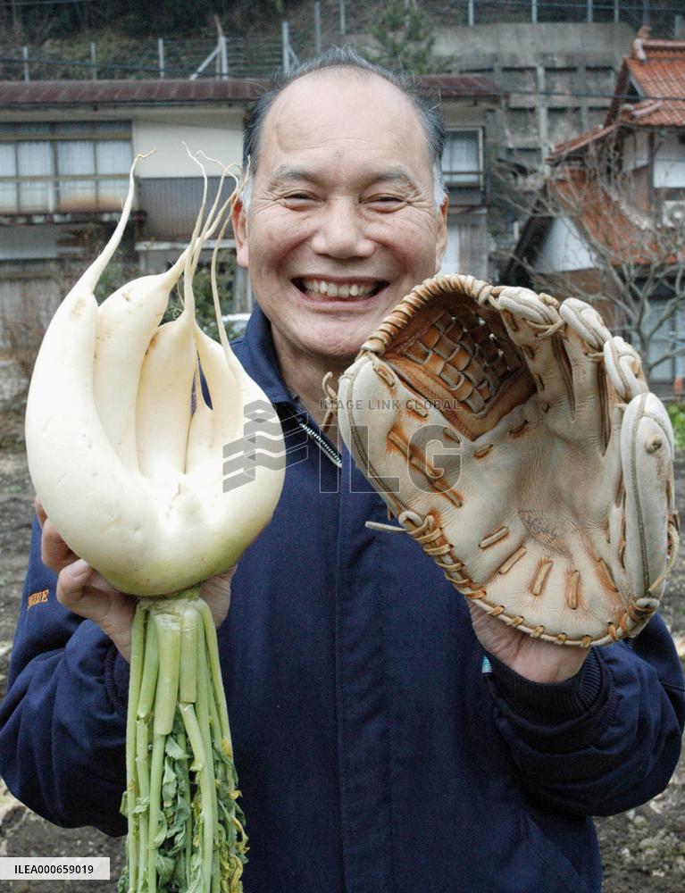 Farmer happy with his glove-shaped radish