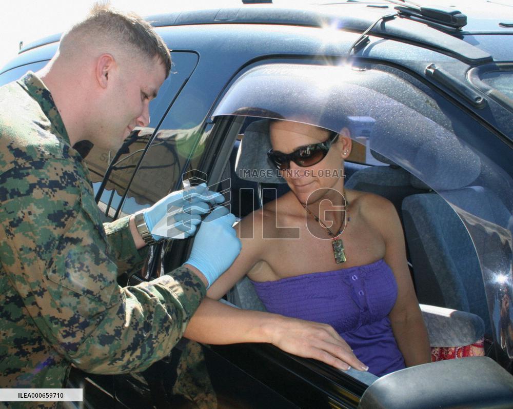 Families of U.S. Marines get flu vaccine shots at drive-thru stat