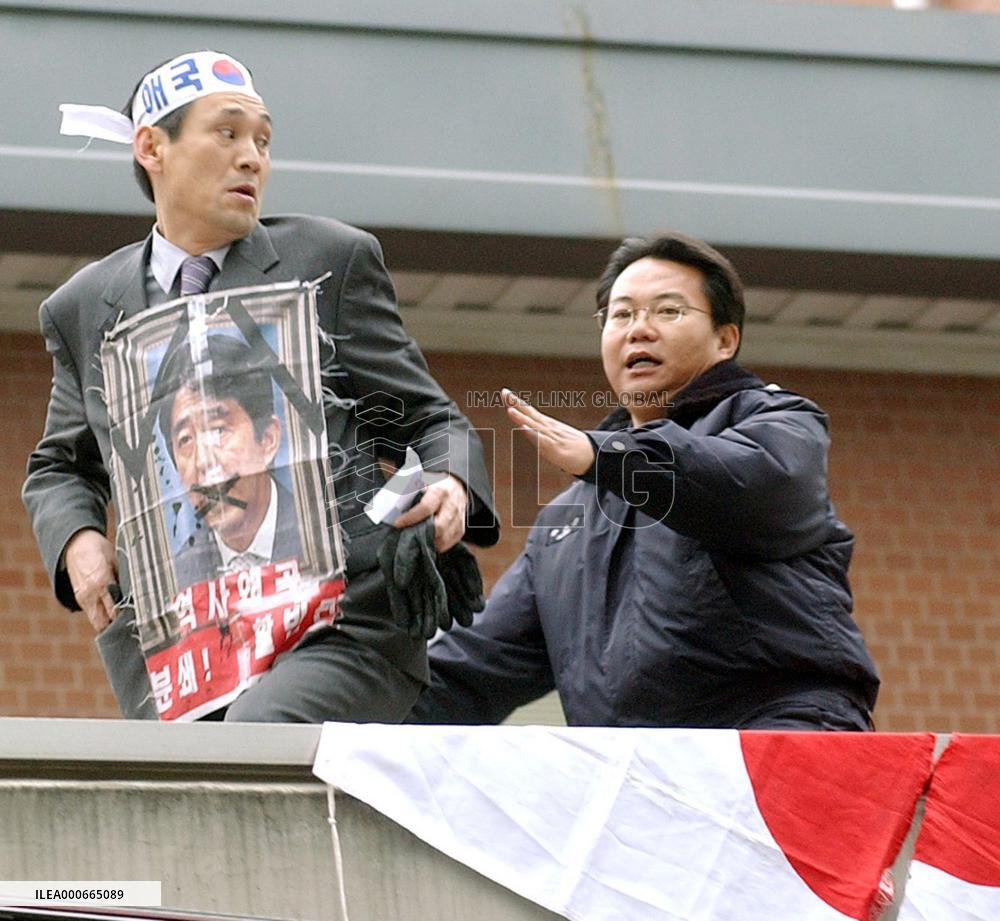 Korean protester climbs onto guard house roof at Japan Embassy