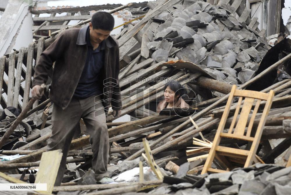 China earthquake -- searching for valuables in destroyed house