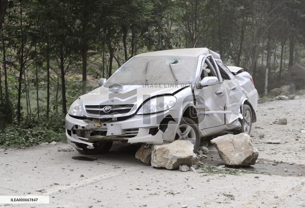 China earthquake -- vehicle crushed by falling rocks
