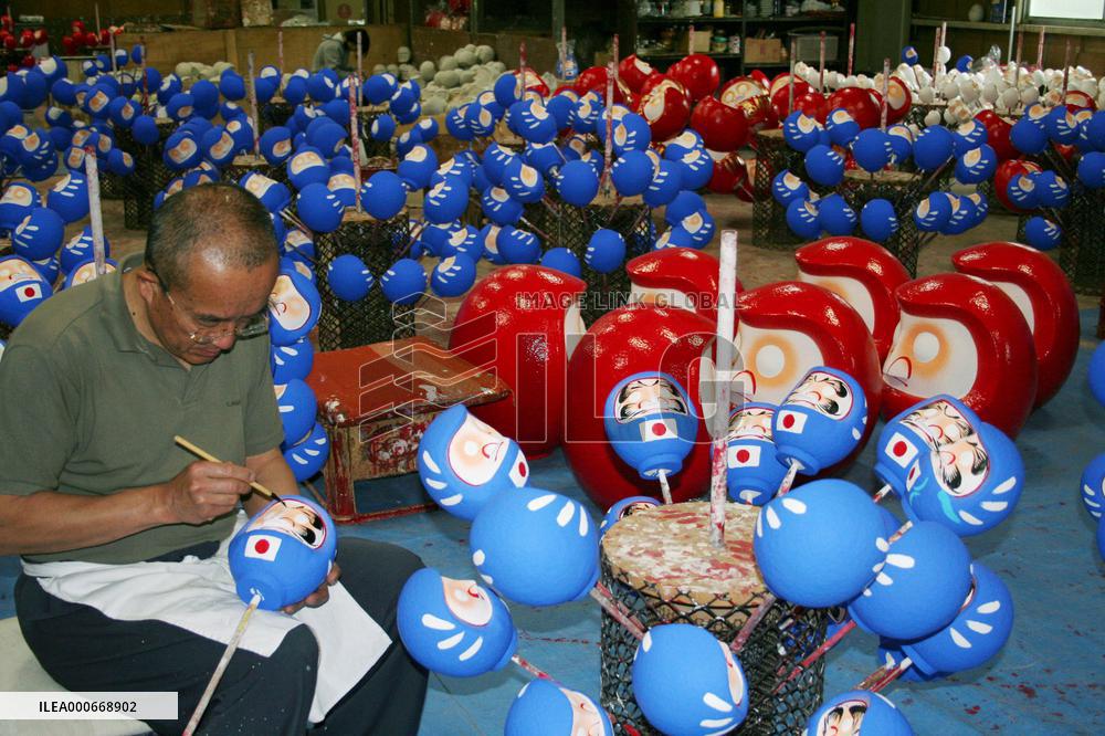 Dharma dolls feature Japan World Cup uniforms