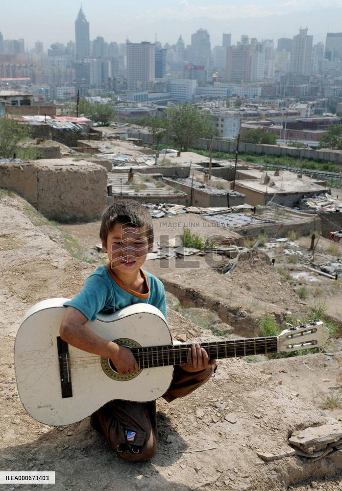 Boy holding guitar in violence-hit Urumqi