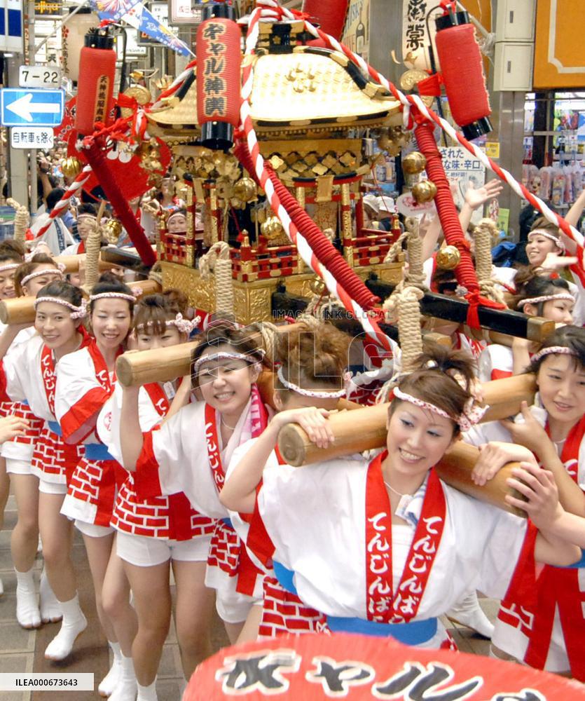 Women carry portable shrine in Tenjin Festival in Osaka