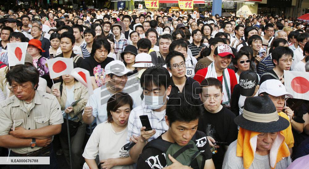 People listen to party leaders' speech during election campaign