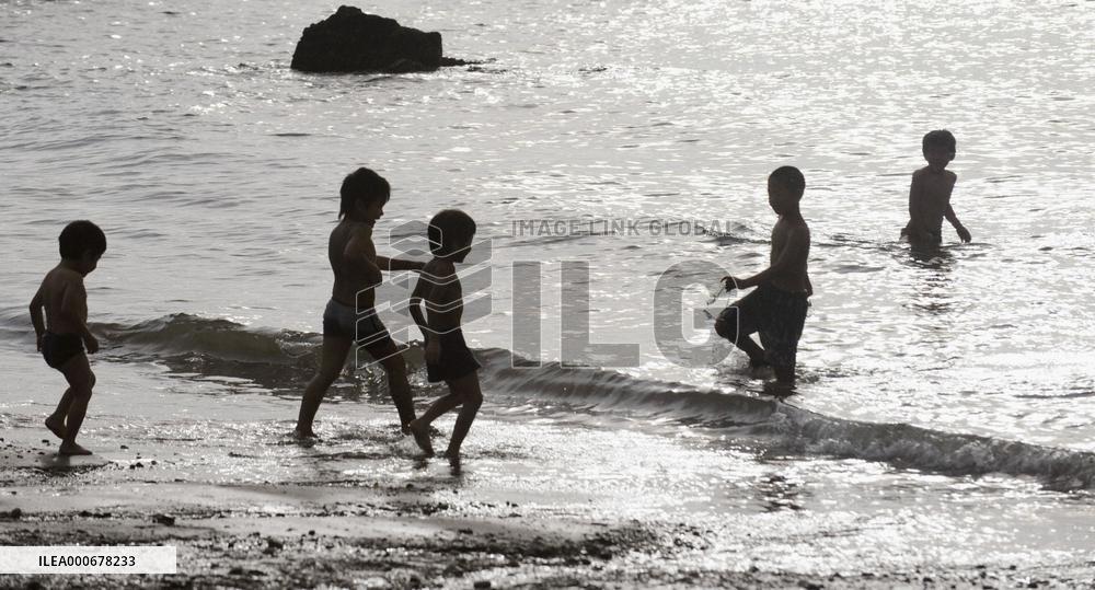 Children play at Akune seashore