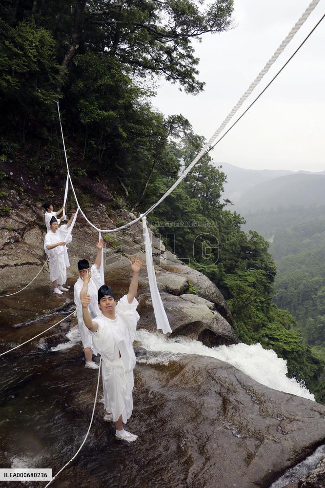 Sacred rope exchange event at western Japan waterfall