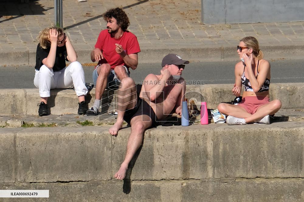 People Enjoying the Warm Weather Paris