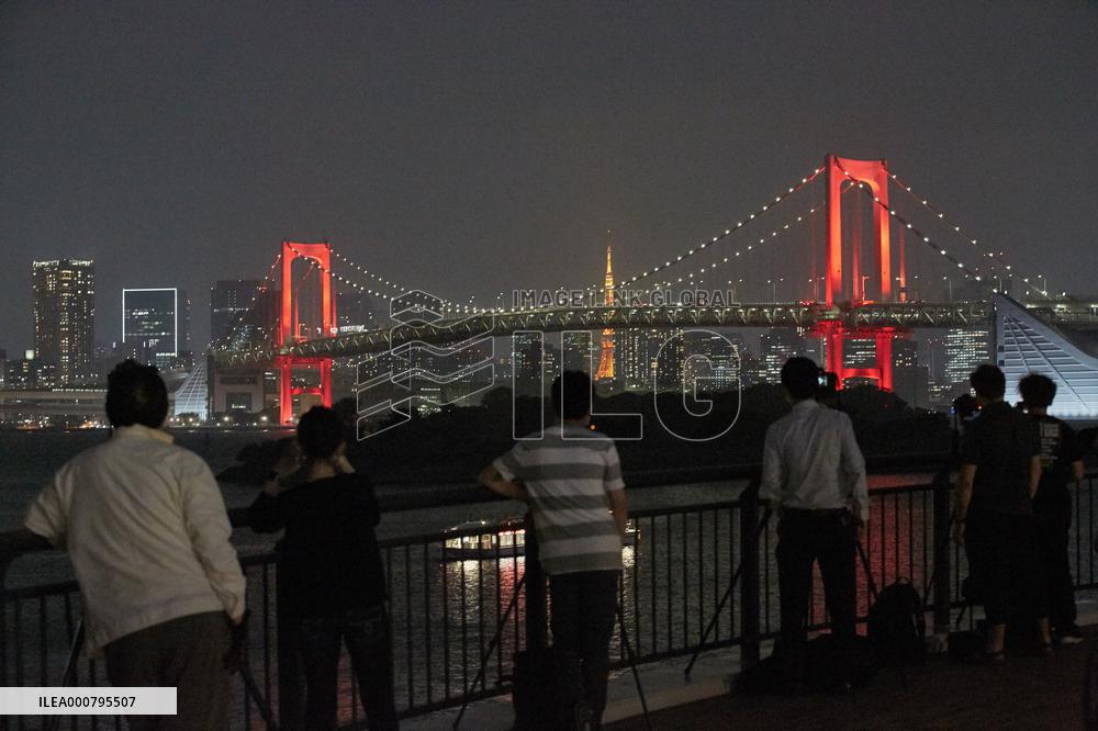 Rainbow Bridge lit up in red