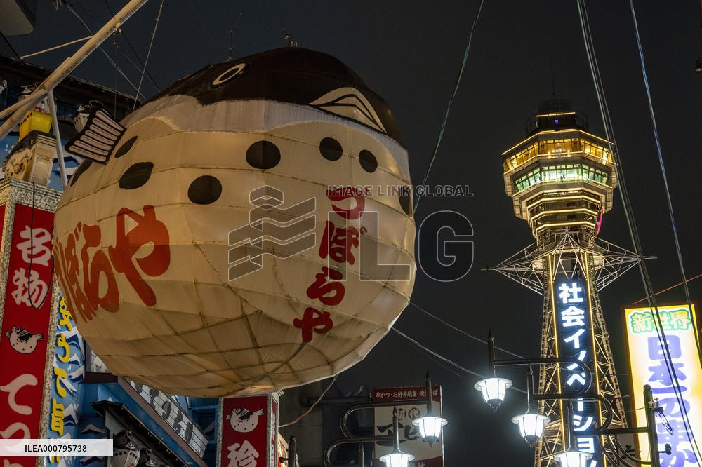Tsutenkaku Tower lit up in yellow due to the spread of new coronavirus infection