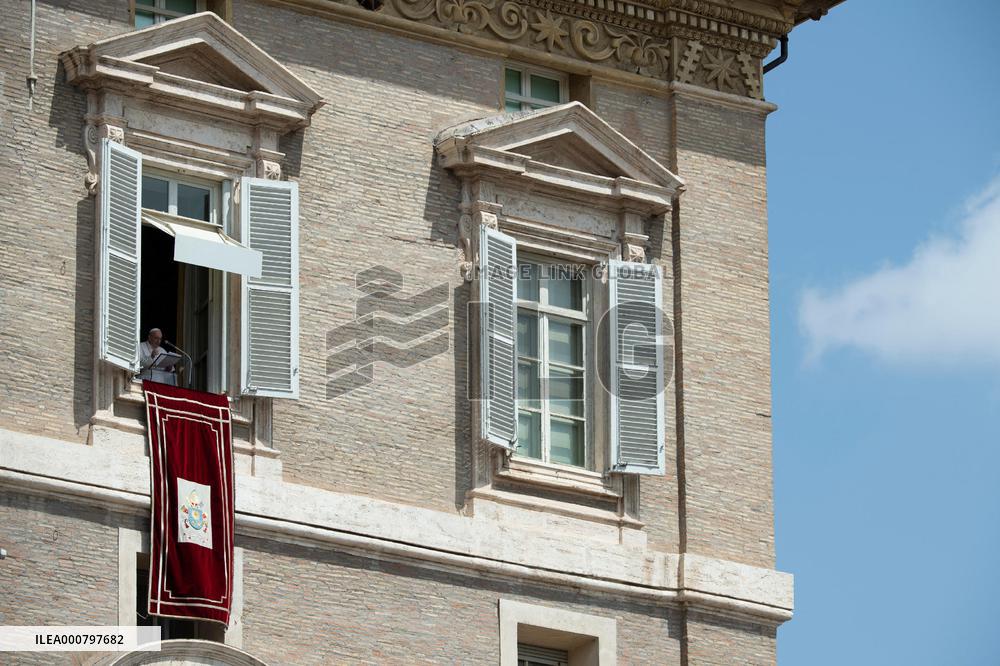 Pope Francis waves from the window of the apostolic palace