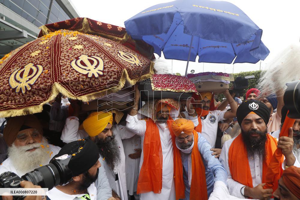 Sikh's Members Carry 3 Saroops Of Sri Guru Granth Sahibat At Airport - Delhi