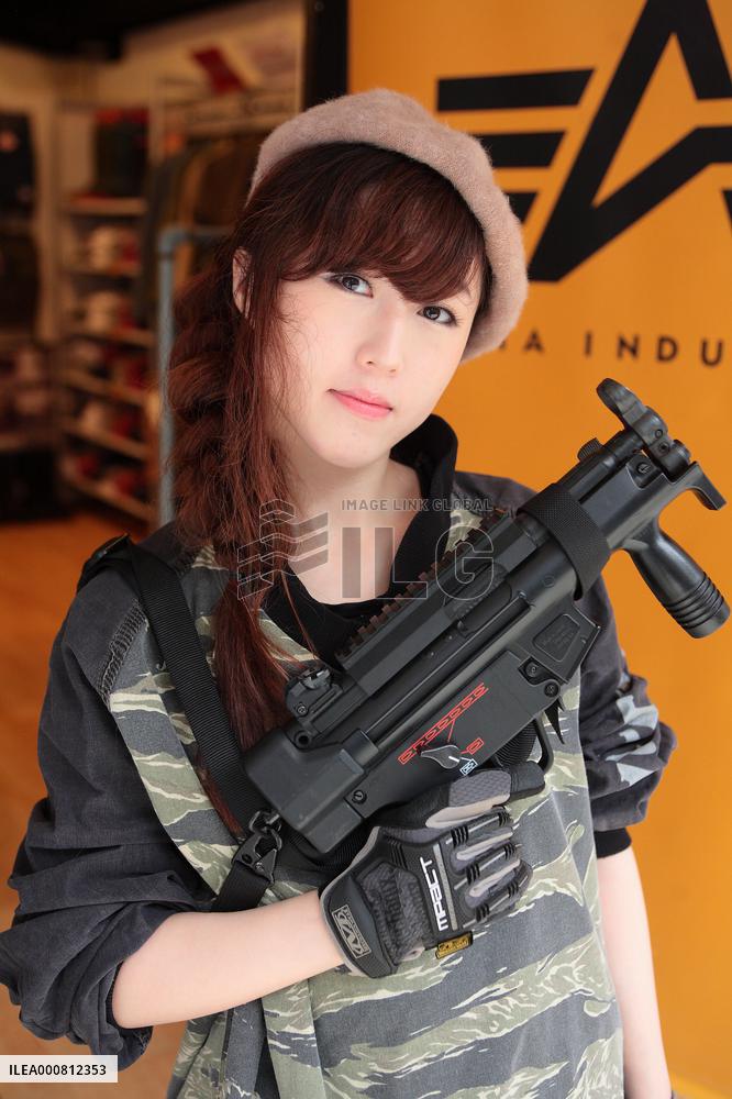 Girls playing an air soft gun (a survival game)