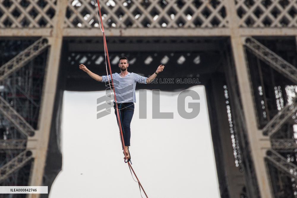 Nathan Paulin Traverses A Slackline Between The Eiffel Tower And The Chaillot Theater