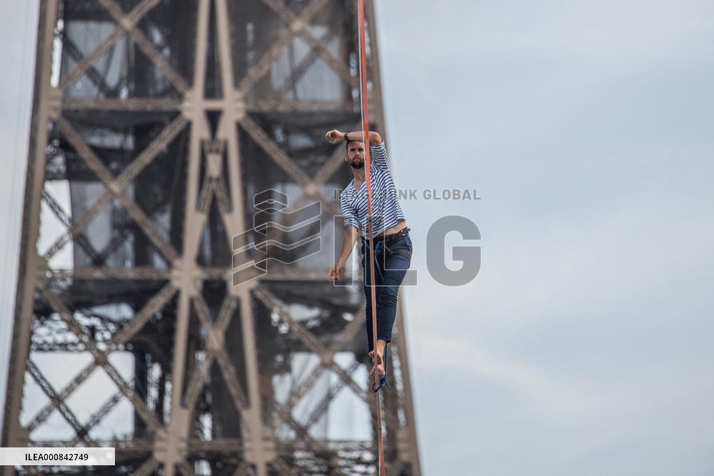 Nathan Paulin Traverses A Slackline Between The Eiffel Tower And The Chaillot Theater
