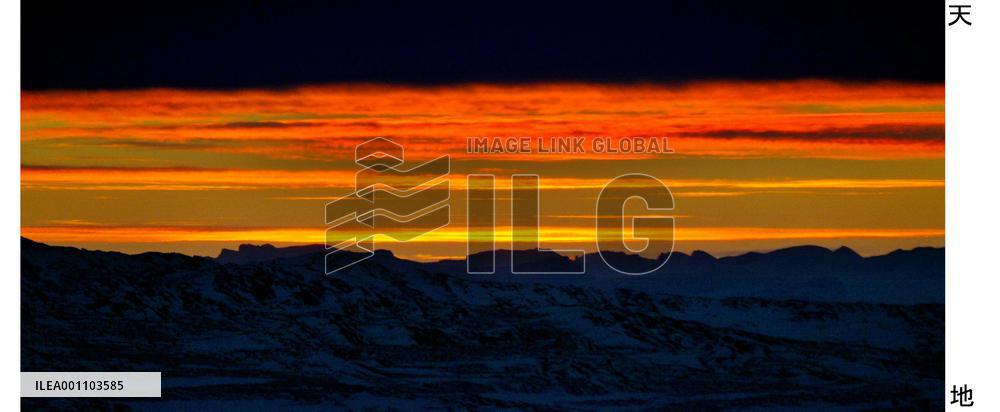 Setting sun paints Antarctic sky bright red