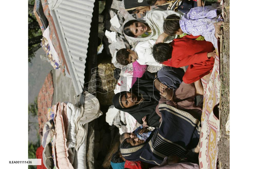 Women, children spend days in front of collapsed house