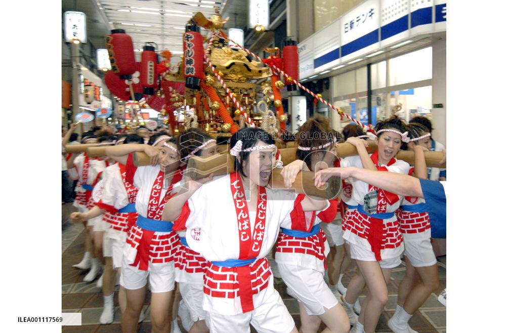 Women carry portable shrine in Tenjin Festival