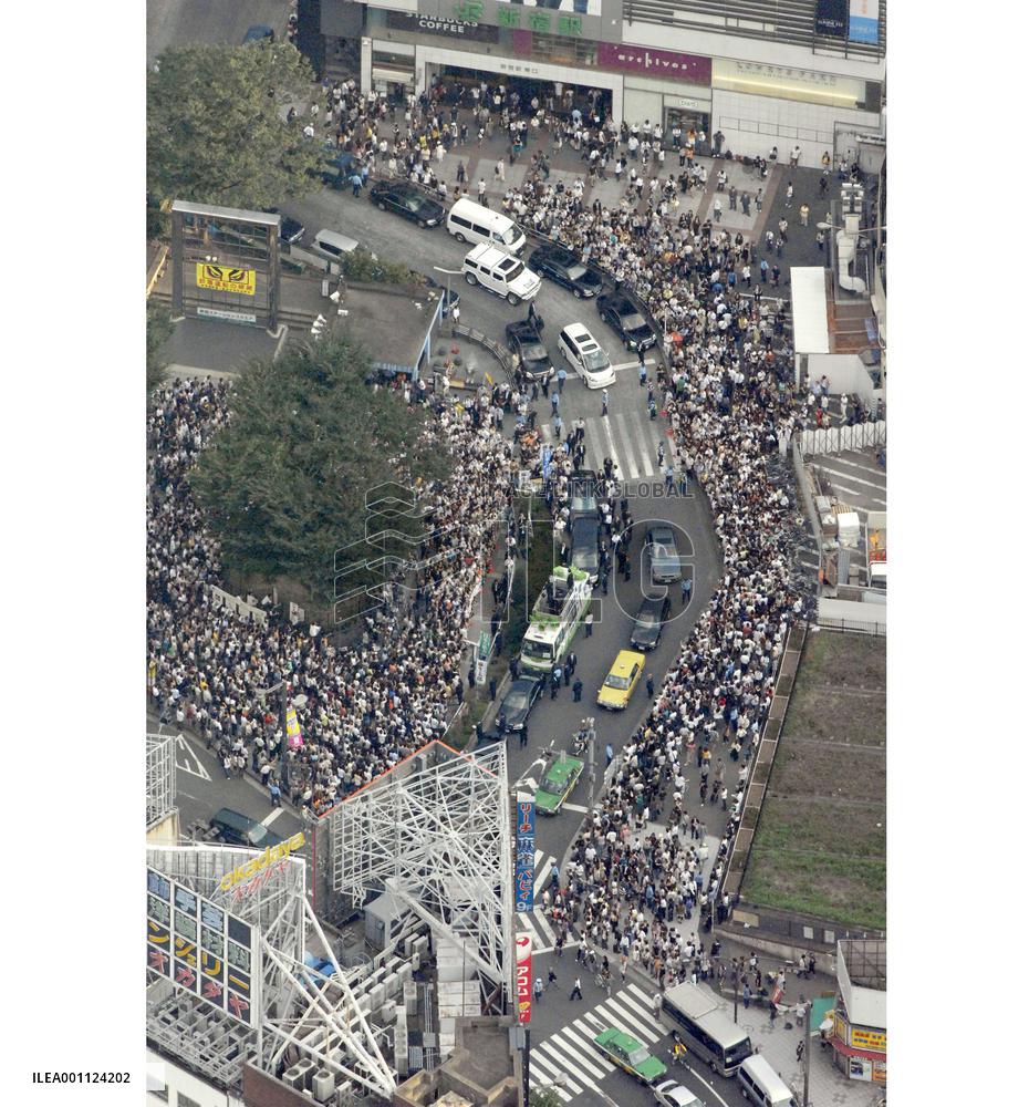 People listen to LDP presidential candidate's speech in Tokyo