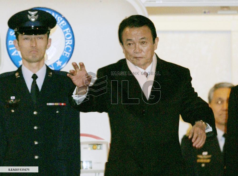 Aso leaves Japan to attend World Economic Forum in Davos