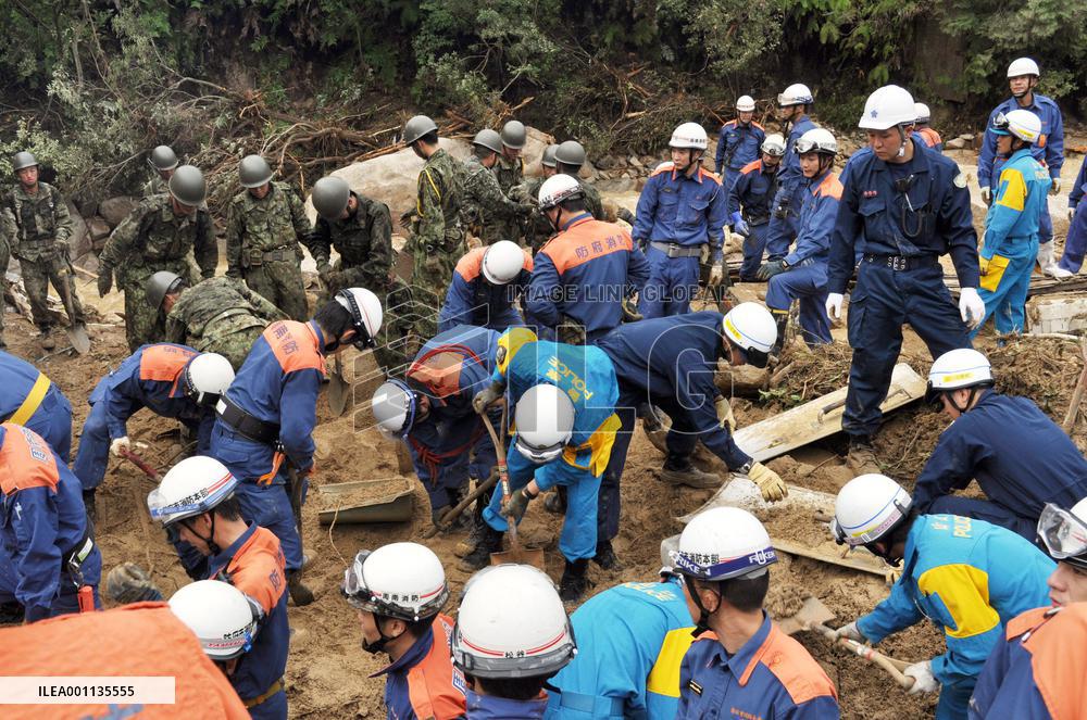 Rescue workers search for people missing in fatal mudslide
