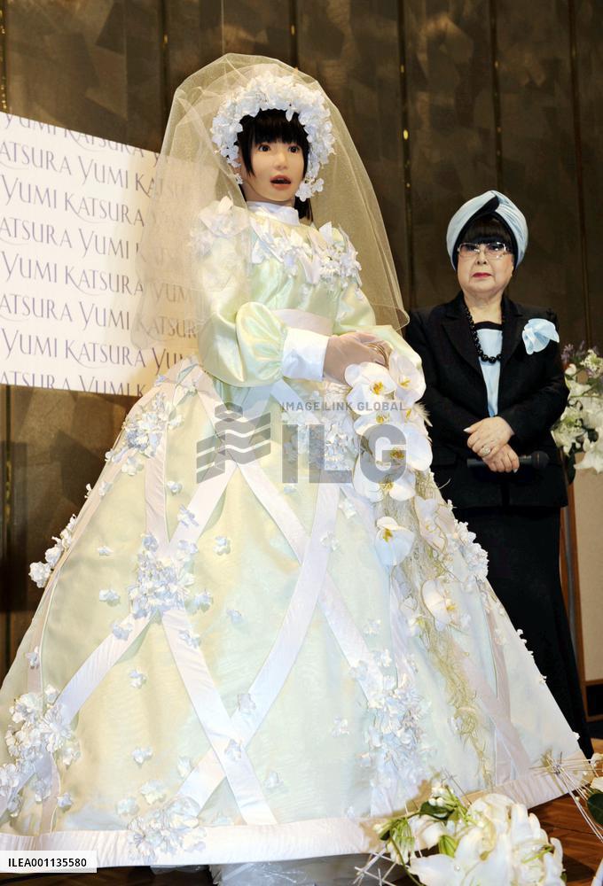 Humanoid model walks on catwalk in wedding gown