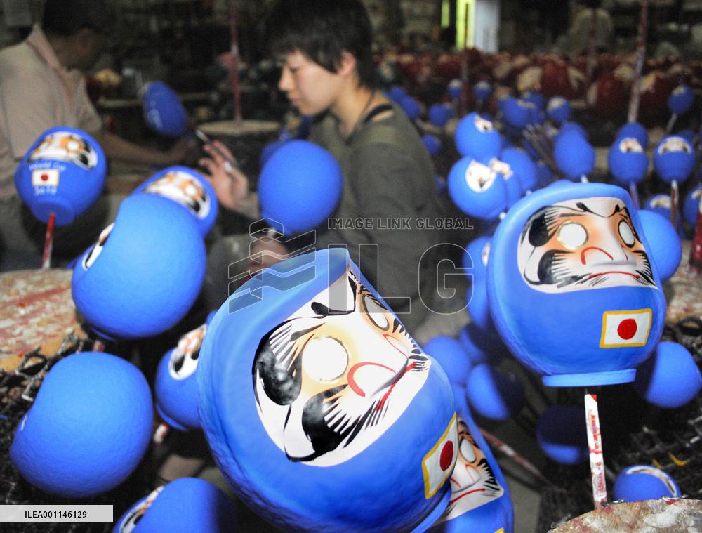 Dharma dolls feature Japan World Cup uniforms
