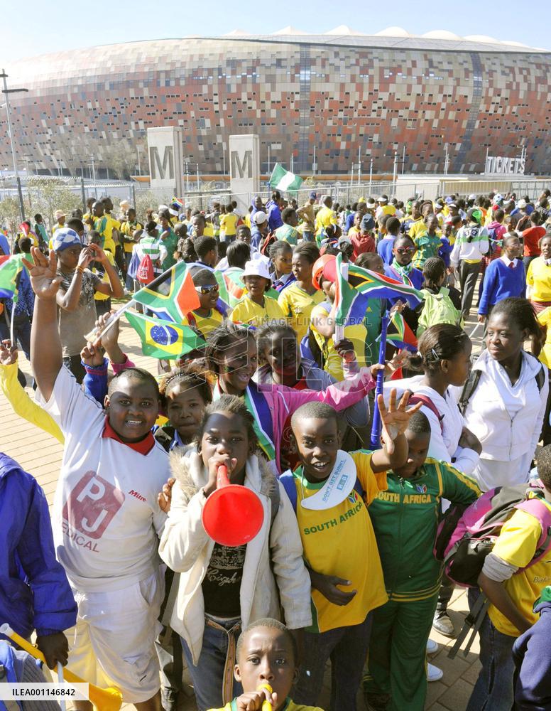 Children cheer near Soccer City