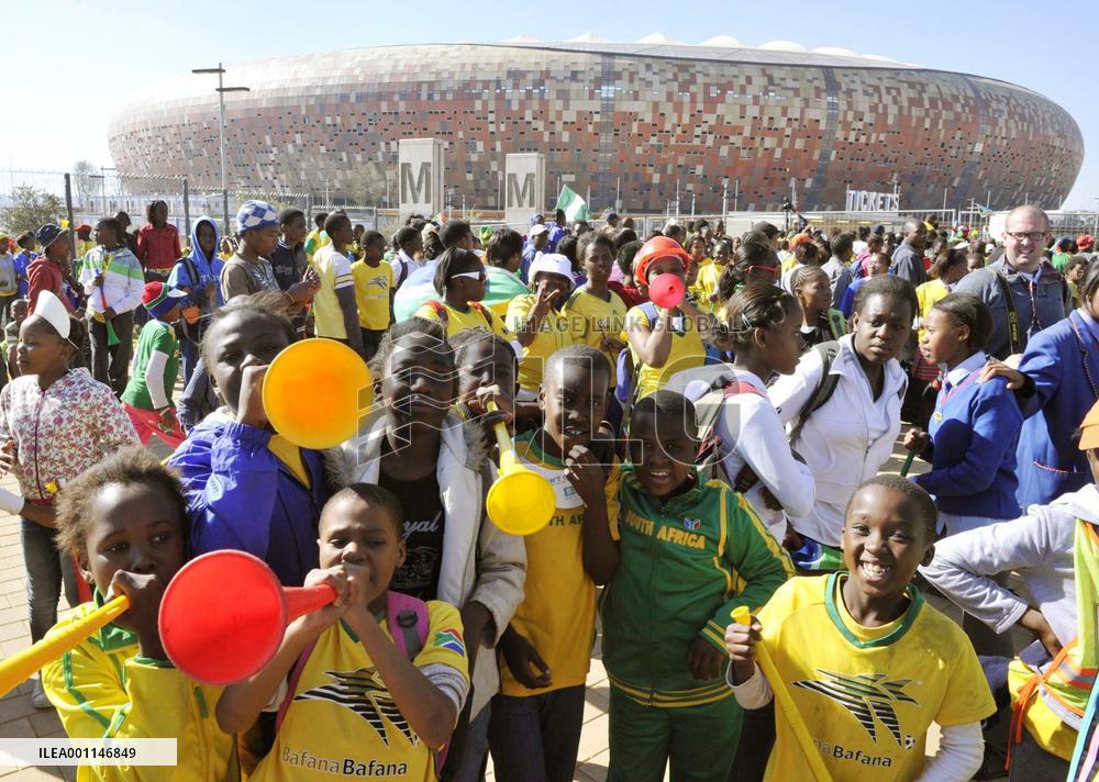 Children cheer near Soccer City