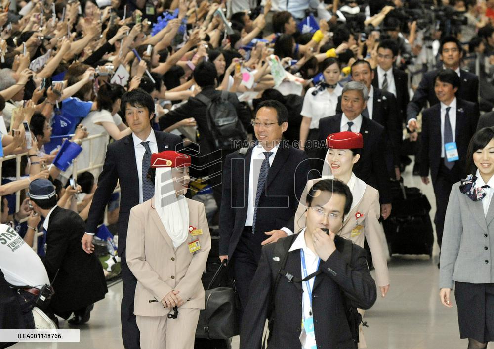 Japan's World Cup squad return home from South Africa