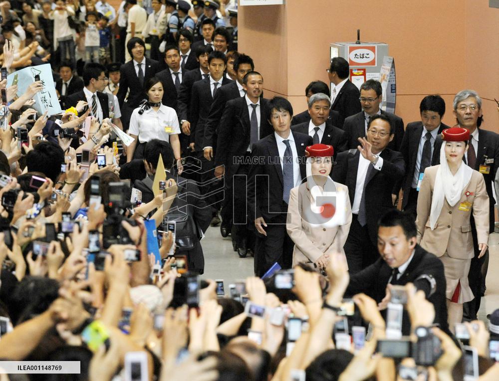 Japan's World Cup squad return home from South Africa