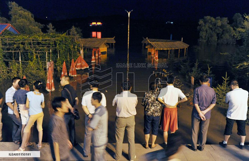 Flood in China's Jilin washes chemical-filled barrels into river