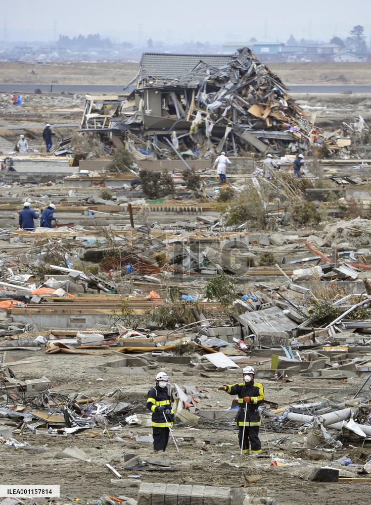 Searching for quake-tsunami victims
