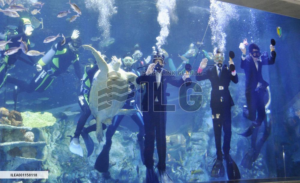 Aquarium's initiation ceremony in water tank