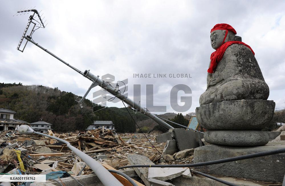 Buddhist deity statue in rubble
