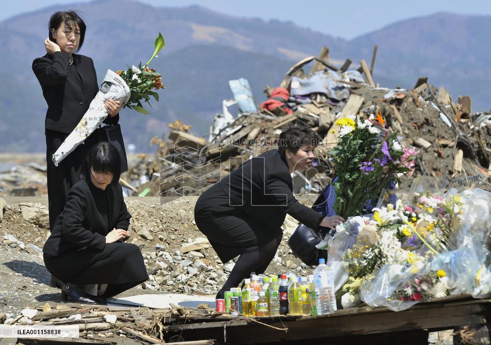 Teachers offer flowers at tsunami-hit elementary school
