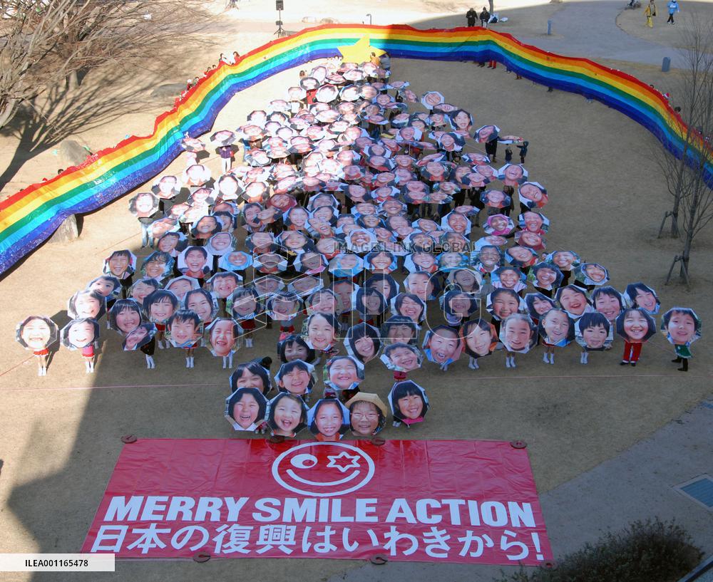Christmas tree formed with smiling faces on umbrellas
